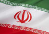 Iranian flag with green, white, red stripes.