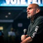 UNEXPECTED Alliance Forms—Democrats Blindsided Completely Man speaking into microphone on stage.
