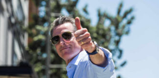 Man giving a thumbs up while wearing sunglasses