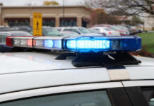 Close-up of a police car's emergency lights in a parking lot