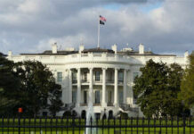 The White House with an American flag flying above it
