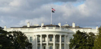 The White House with an American flag flying above it