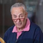 Shock Move: Schumer Faces Giant Progressive Revolt A man with glasses speaking at a press conference