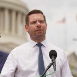 Shocking Fraud Claims Rock Gubernatorial Hopeful’s Campaign A politician speaking at a press conference outdoors with a microphone