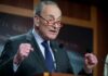 Trump SLAMS Schumer: DHS Shutdown Madness A politician delivering a passionate speech at a podium