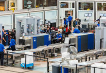 Airport security checkpoint with travelers and TSA agents