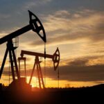 Hormuz Crisis: US Scrambles to Avoid Fuel Spike Silhouetted oil pumps against a colorful sunset sky