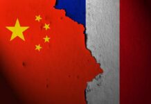 A textured wall displaying the flags of China and France