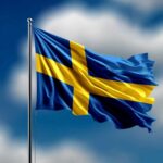 Waving flag of Sweden against a blue sky