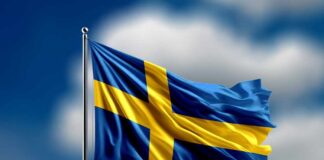 Waving flag of Sweden against a blue sky