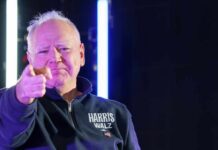 A person pointing confidently at the camera with a serious expression