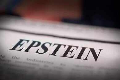 Close-up of a newspaper headline reading 'EPSTEIN'