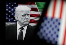 Black and white portrait of a political figure in front of an American flag