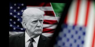 Black and white portrait of a political figure in front of an American flag