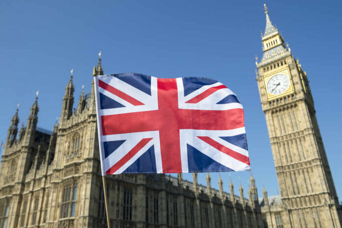 Union Jack flag in front of Big Ben and the Houses of Parliament