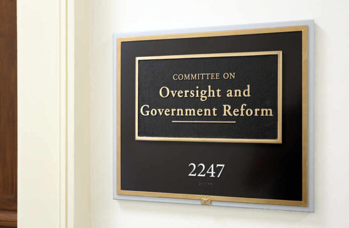 Sign for the Committee on Oversight and Government Reform in an office building