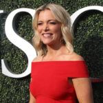 Smiling woman in a red off-shoulder dress at an outdoor event