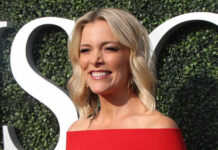Smiling woman in a red off-shoulder dress at an outdoor event
