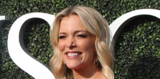 Smiling woman in a red off-shoulder dress at an outdoor event