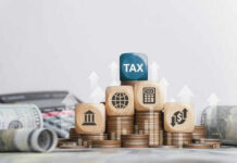 40% Exit Tax TRAP—Wealthy Americans Cornered Wooden blocks on stacked coins with tax symbols