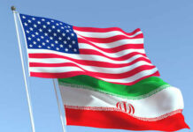 American and Iranian flags waving in the sky.