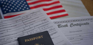 Passport and documents on table with American flag