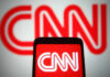 CNN logo displayed on phone and screen.