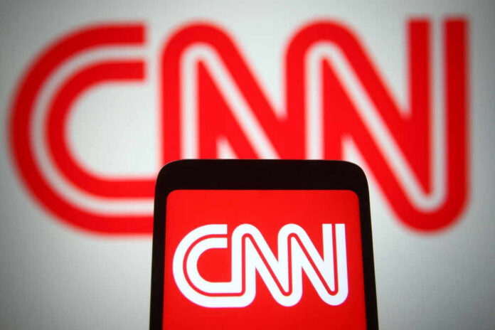 CNN logo displayed on phone and screen.
