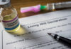 A vial of pentobarbital next to a living will declaration form and a fountain pen