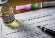 A vial of pentobarbital next to a living will declaration form and a fountain pen