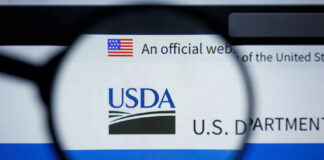 Close-up view of the USDA website logo through a magnifying glass