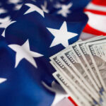 American flag with hundred dollar bills