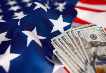 American flag with hundred dollar bills