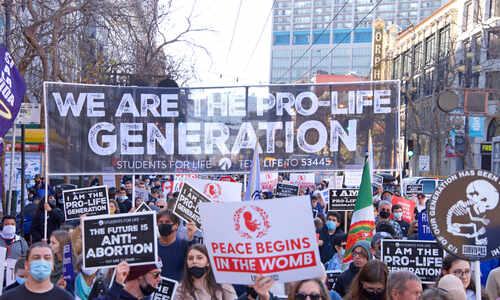 Crowd of protesters holding signs at a pro-life demonstration