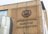 Facade of the International Maritime Organization building with a prominent sign