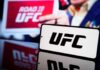UFC logo displayed prominently with a blurred background of a promotional sign