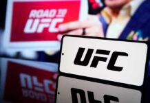 UFC logo displayed prominently with a blurred background of a promotional sign