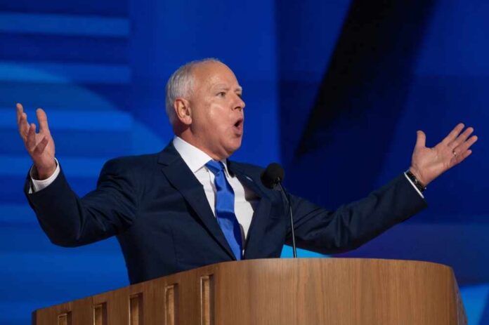 A man in a suit passionately delivering a speech at a podium