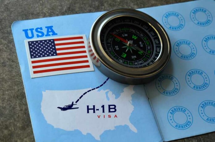 A compass placed on an H-1B visa document with a USA flag