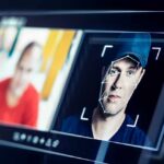 A digital interface displaying facial recognition analysis of two individuals