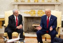 Two political leaders engaged in discussion in a formal setting