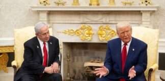 Two political leaders engaged in discussion in a formal setting