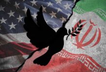 A dove with an olive branch overlaid on the flags of the United States and Iran
