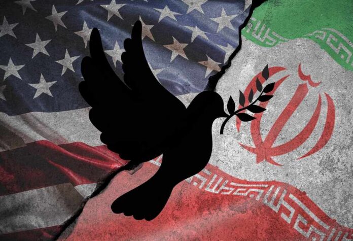 A dove with an olive branch overlaid on the flags of the United States and Iran