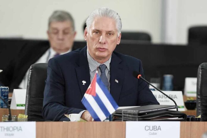 Cuban representative at a political meeting with a flag on the table