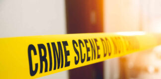 Yellow crime scene tape with the words 'CRIME SCENE DO NOT CROSS'