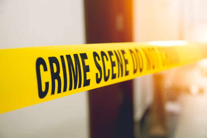 Yellow crime scene tape with the words 'CRIME SCENE DO NOT CROSS'