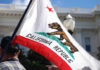 High-Speed Rail Dreams Shattered: Billions Wasted! California state flag being held up at an outdoor event