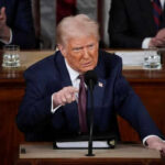 DHS Funding Chaos: Trump’s Bold Filibuster Ultimatum Man in suit speaking at a podium during an event