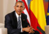 Photo Evidence: Obama Cozy With Communist Leader Man in a dark suit seated with flags in the background